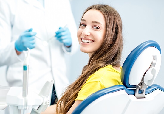 smiling woman sitting in a dental chair