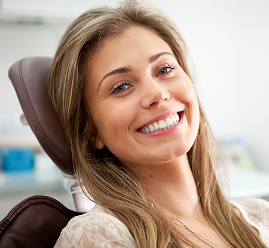 smiling woman sitting in a dental chair