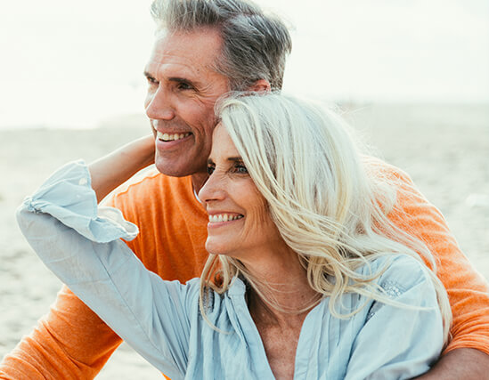 smiling senior couple on the beach