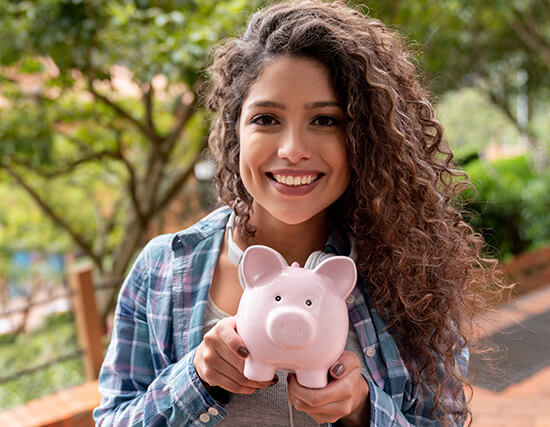 woman holding a piggy bank