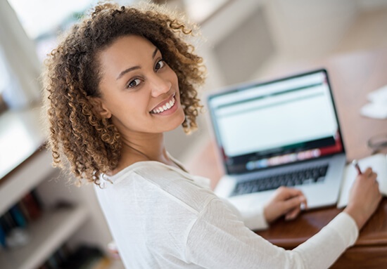 woman sitting in front of a laptop