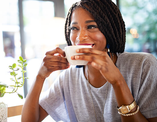 woman sipping a cup of coffee