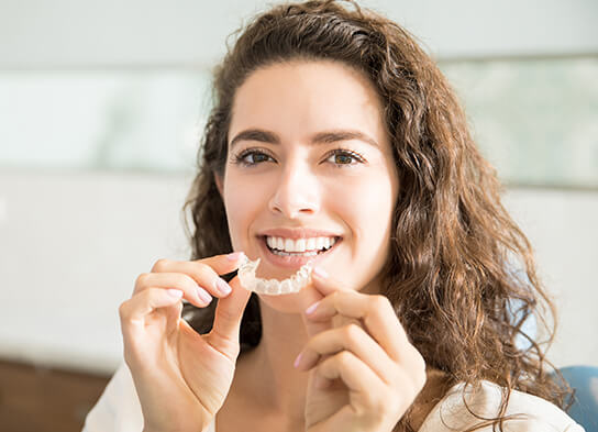 woman inserting her Snap-On Smiles on her teeth